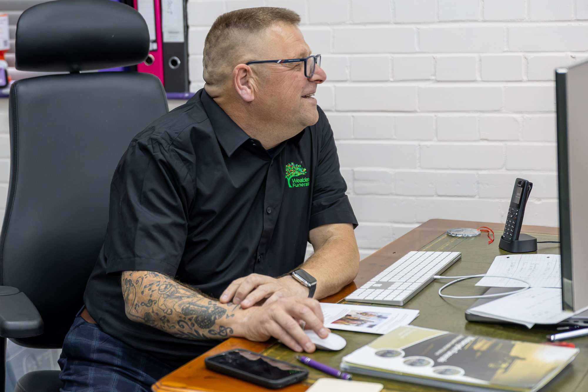 Andy reviewing funeral information and choices at his desk