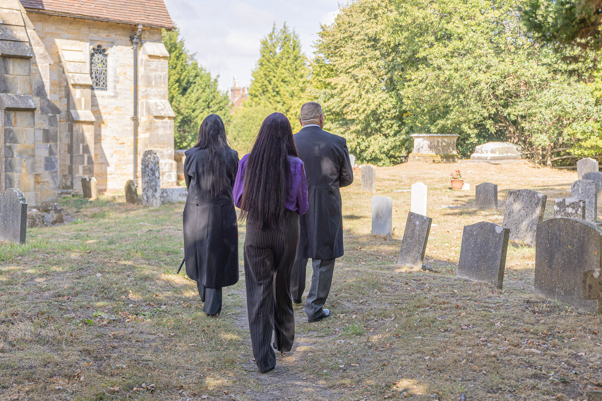 Stacie, Tiah and Andy walking through Waldron churchyard