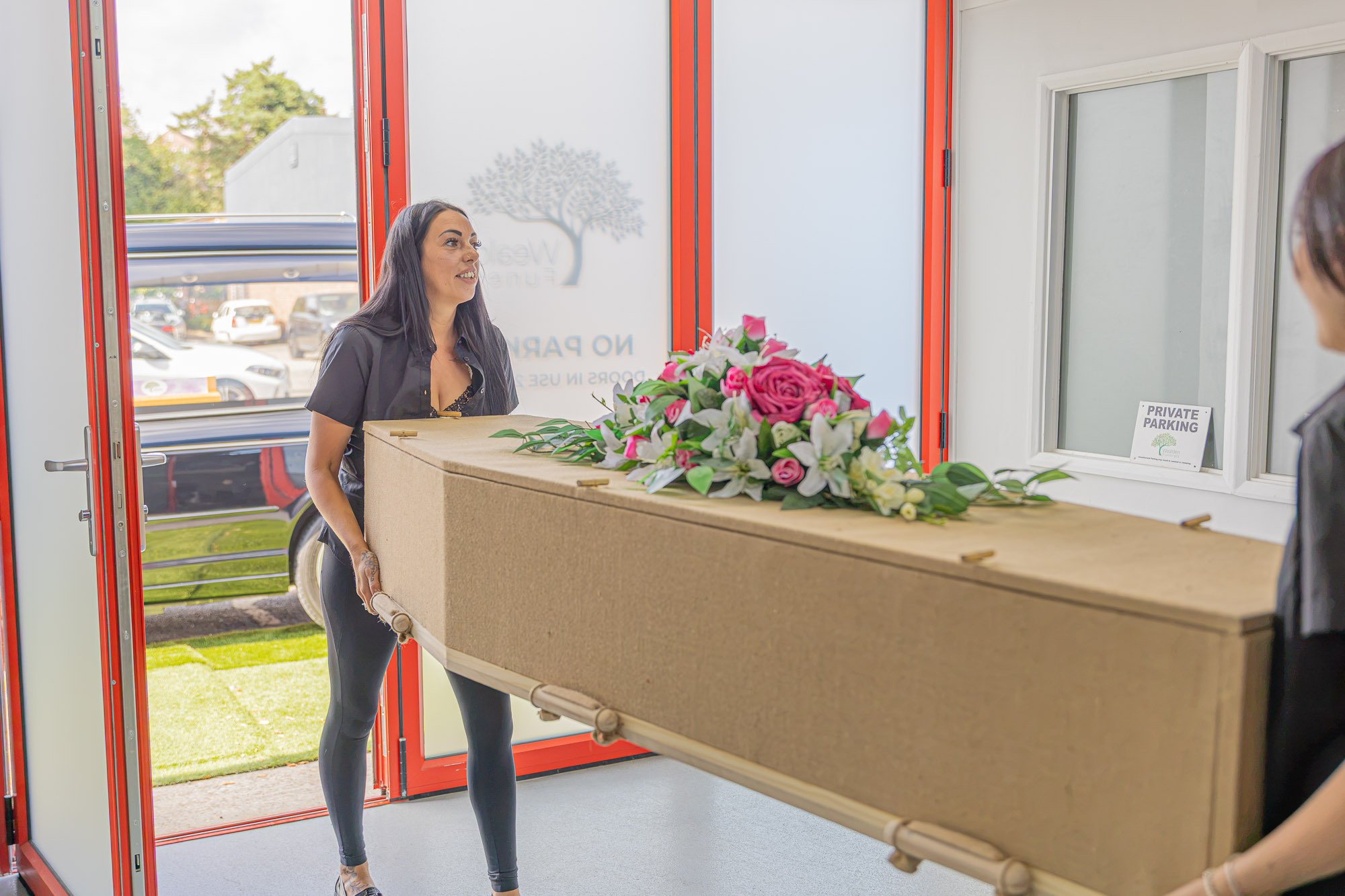 A natural coffin being taken carefully from the Wealden funeral home