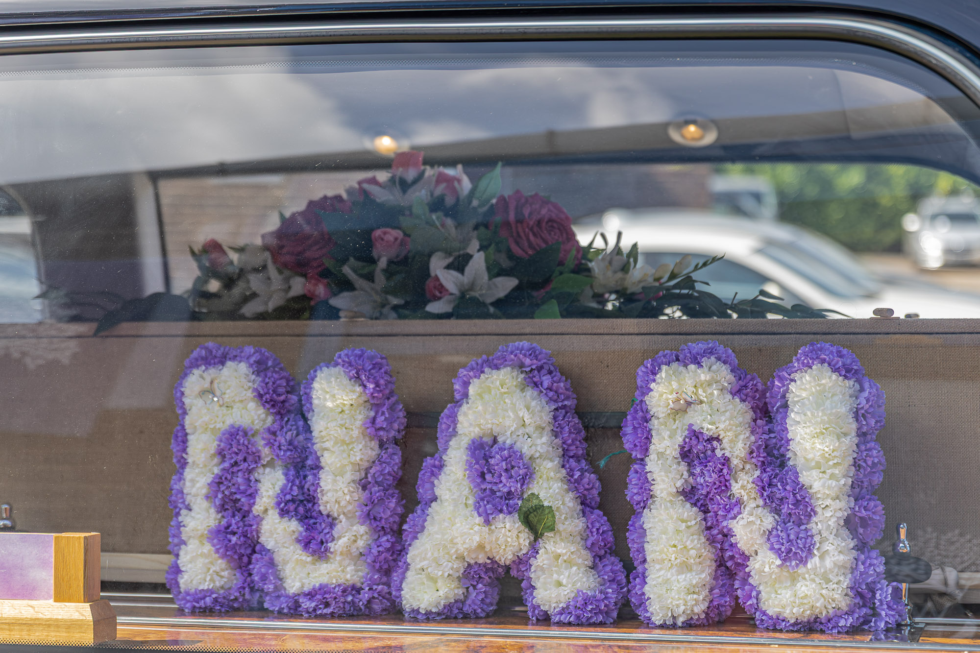 A personal NAN floral tribute arranged in the Wealden hearse