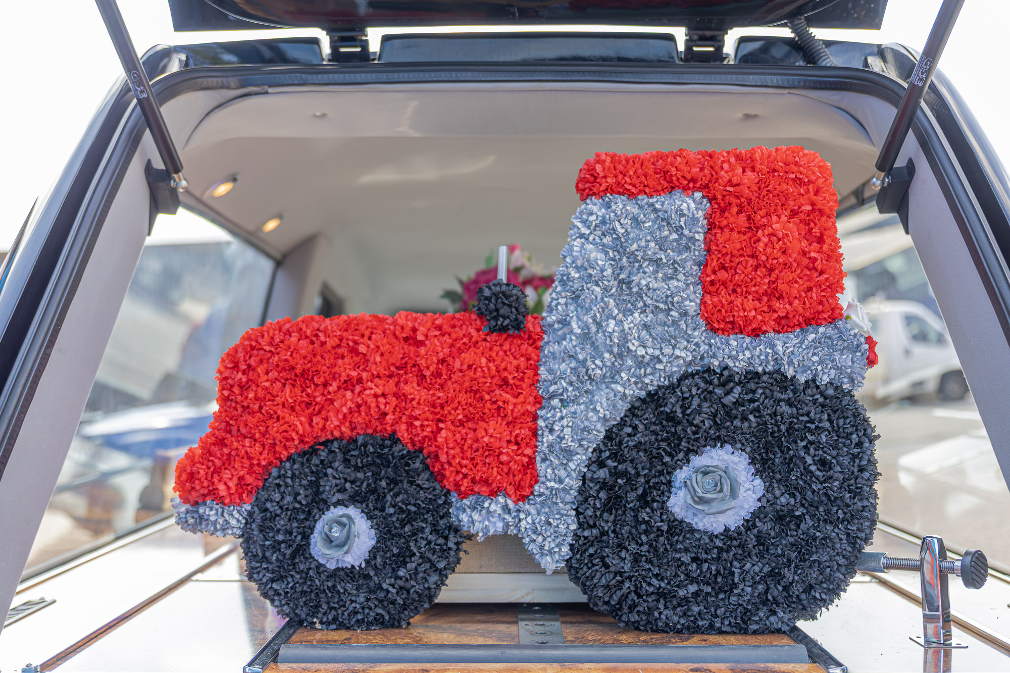 A tractor-shaped floral tribute displayed in the Wealden hearse