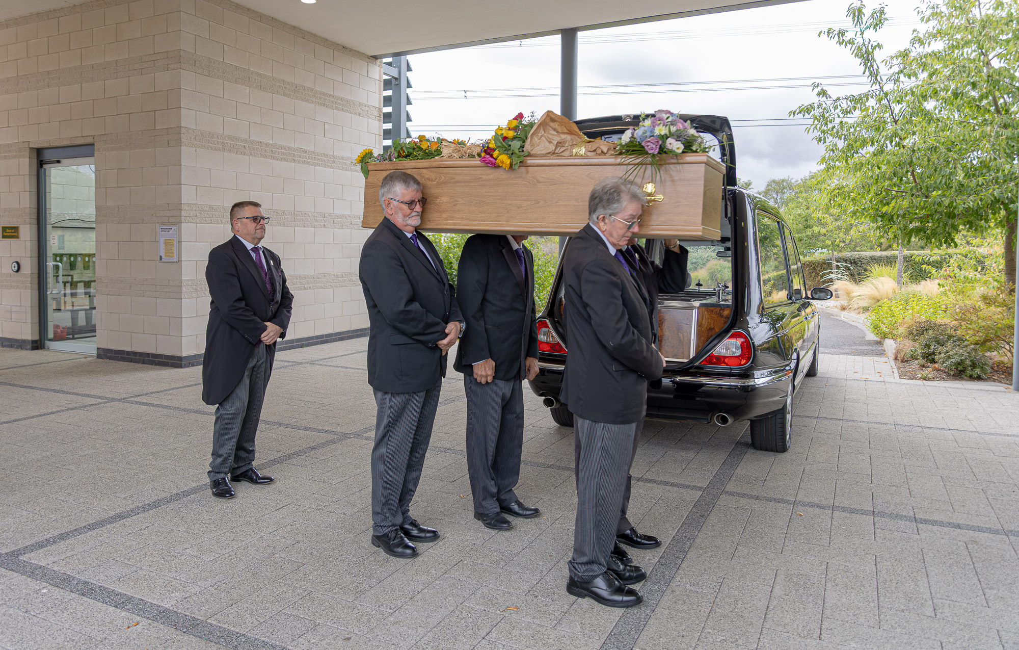 The Wealden funeral team carrying a coffin into the crematorium