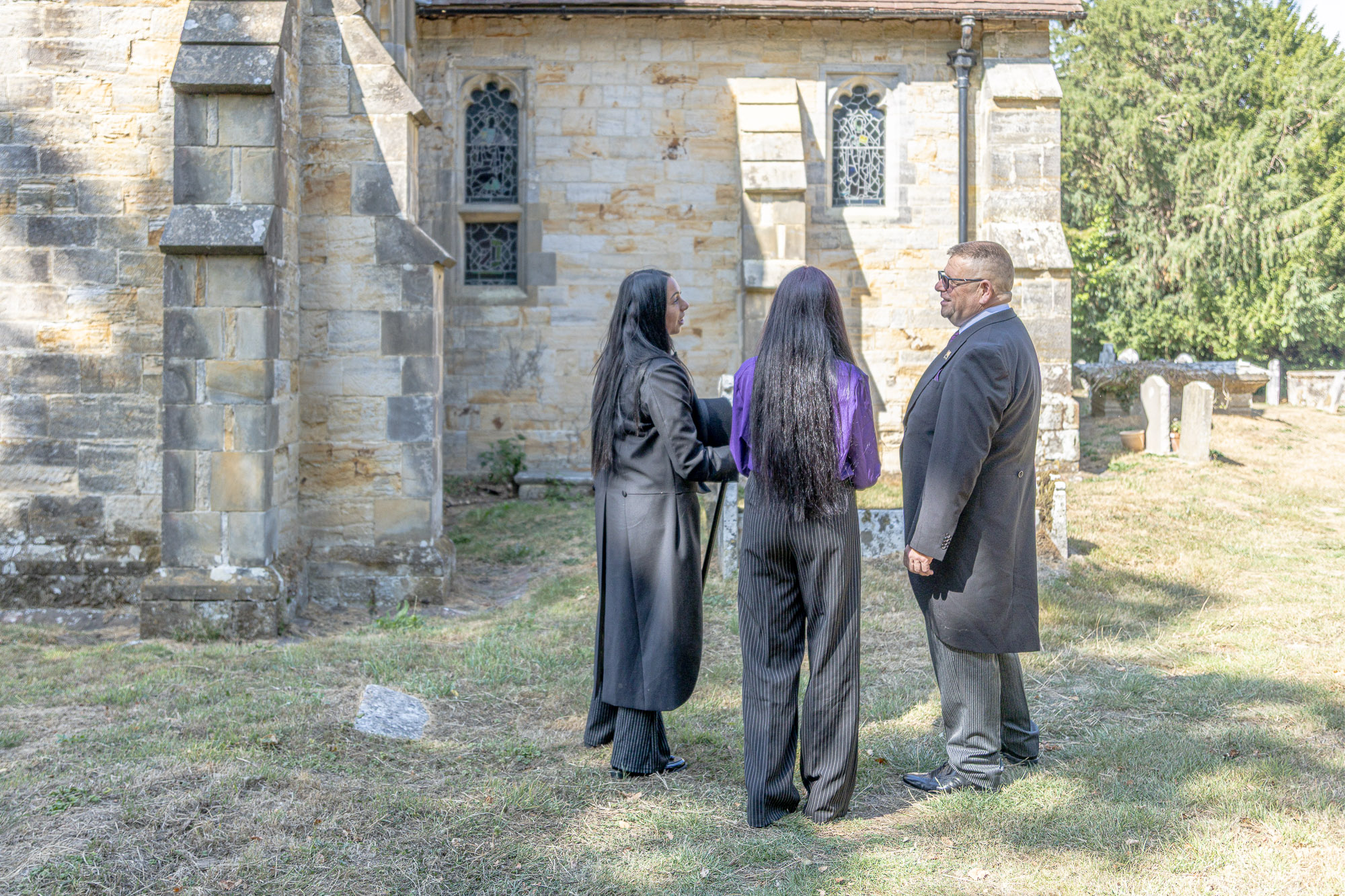 Stacie, Tiah and Andy talking together in Waldron churchyard