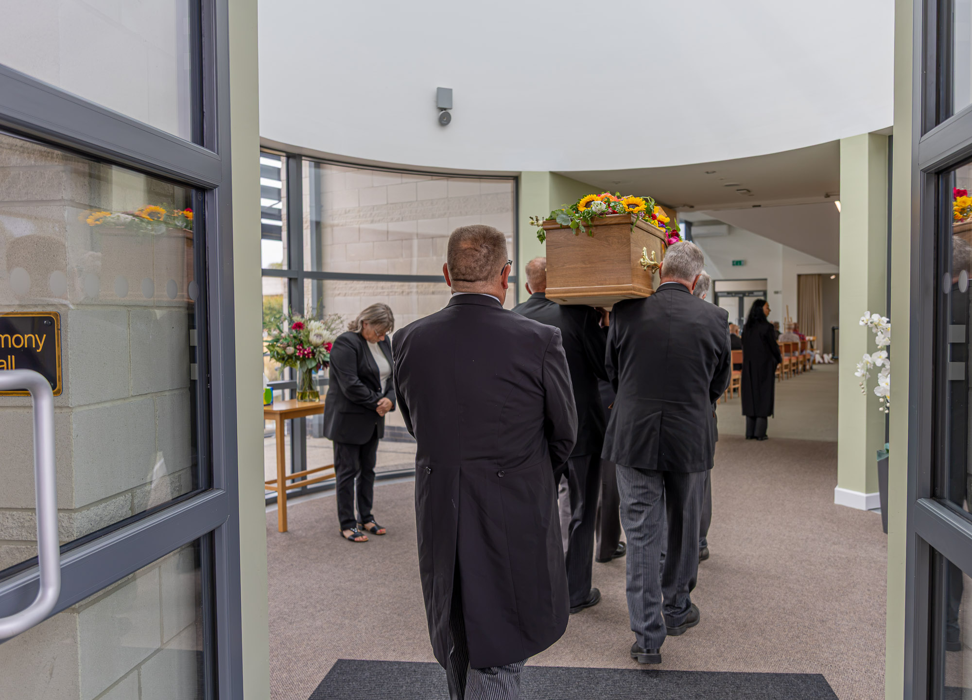 The Wealden funeral team accompanying a coffin into Wealden Crematorium