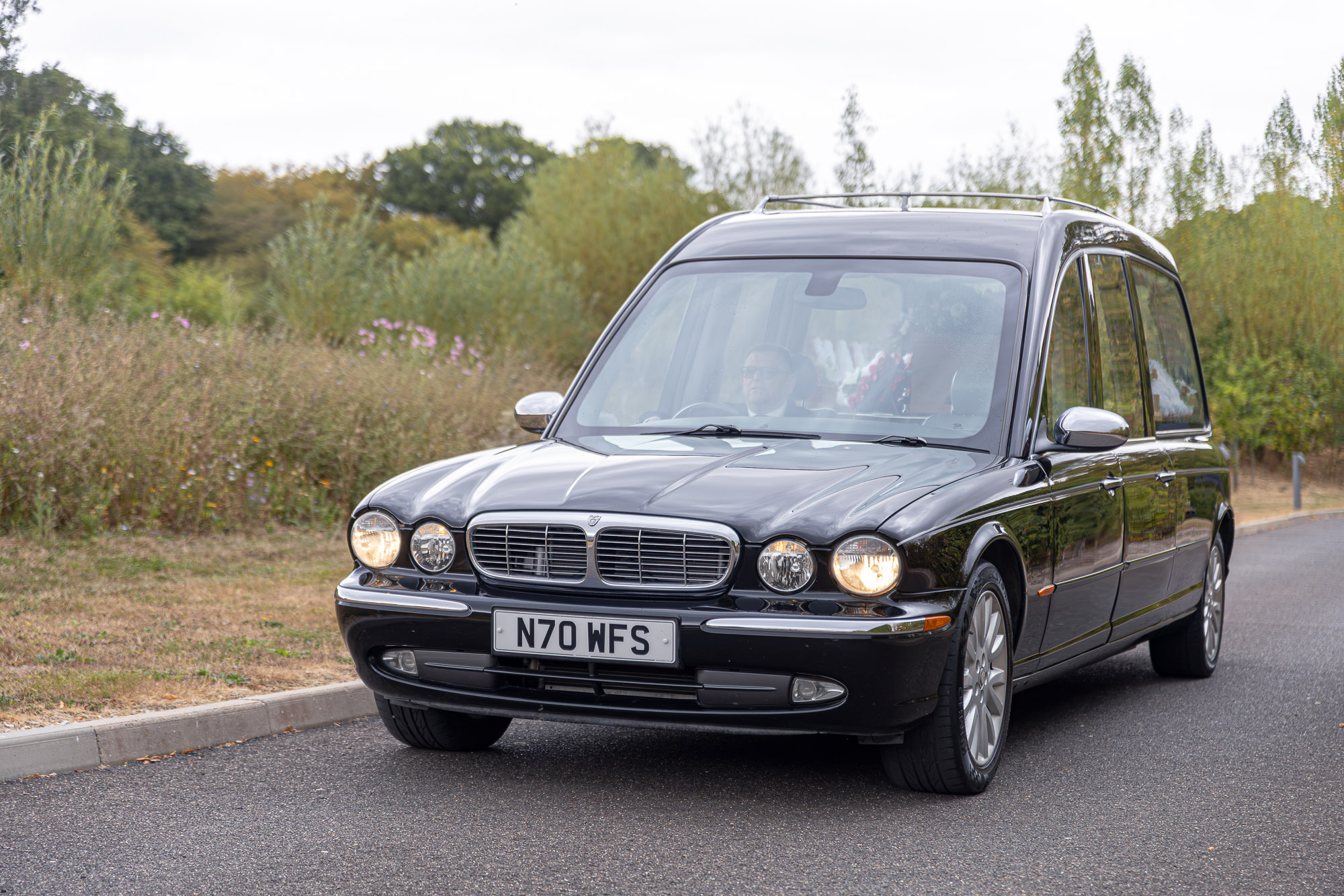 The Wealden hearse travelling along a quiet country road