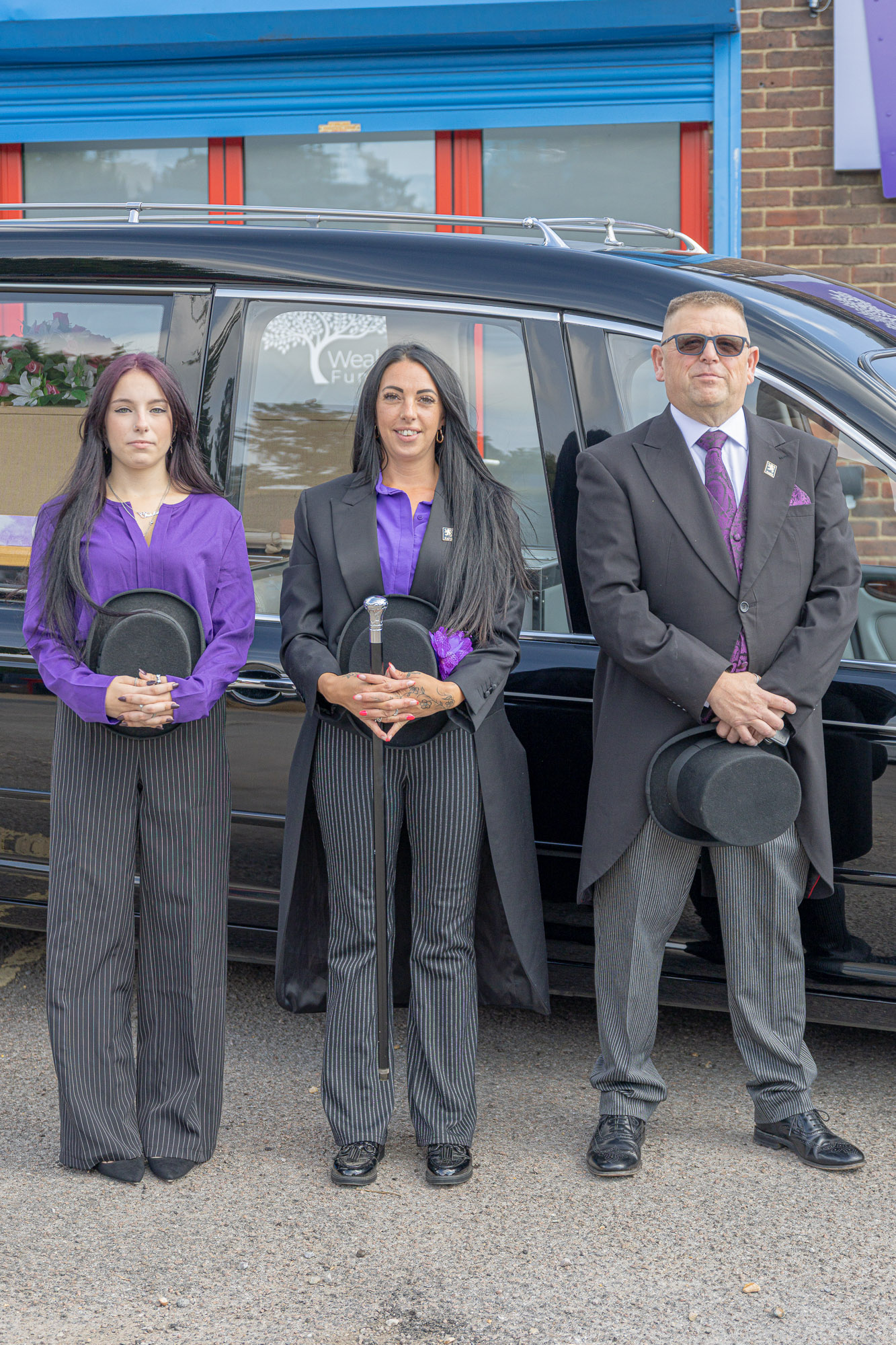 Tiah, Stacie and Andy from Wealden Funeral Services beside the hearse